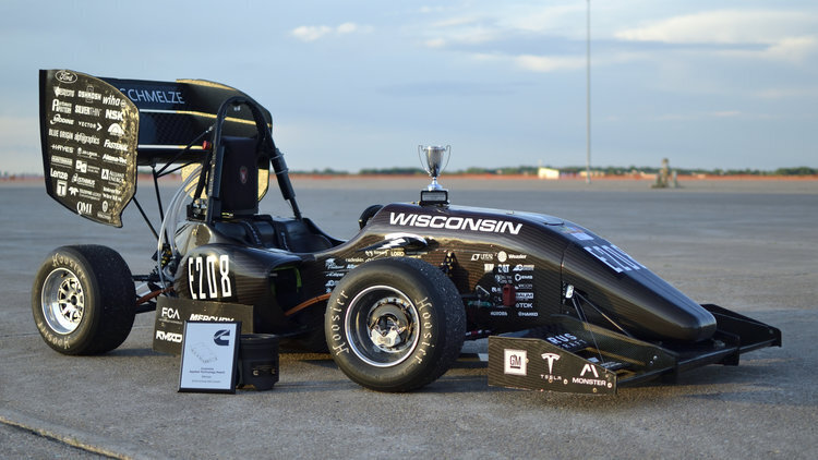 The 218e featured a redesigned high voltage battery, student-designed motors and motor controllers, and custom high torque density compound planetary transmissions. The improved four-motor electric powertrain, paired with the hybrid monocoque and redesigned spaceframe, offered a 20% decrease in weight.